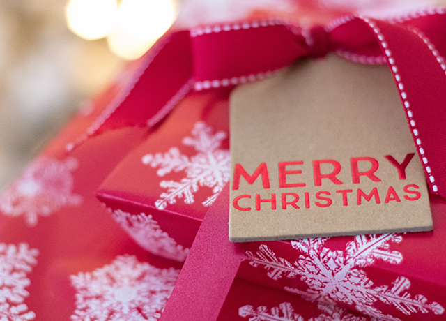 Merry Christmas auf Schild an rotem Geschenk Goldschmiede Albath